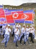 North Koreans march to celebrate liberation anniversary