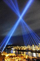 Laser beams illuminate night sky in downtown Vancouver