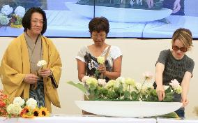 Milan expo visitors try flower arrangement at Japan Pavilion