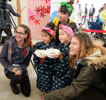 Expo Milano visitors pose for photos with kids from Japan's Yamagata