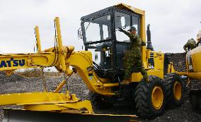 Japanese soldier helps training in use of heavy machinery in Africa