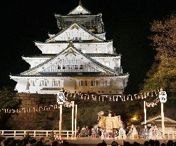 Noh play performed on outdoor stage under Osaka Castle tower