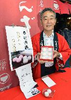 Store owner shows cake marking princess's wedding