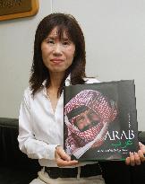 Japan photographer holds photo book of Syrian nomads