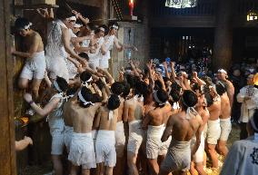 Half-naked young men jostle at northwestern Japan festival