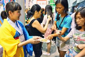 Visitors get Japanese rice crackers at Hong Kong food fair