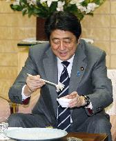 Japan PM Abe tastes tiger puffer fish