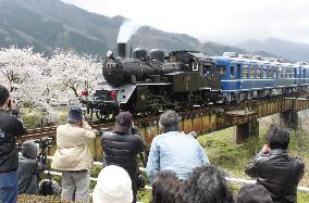 Steam locomotive train runs on bridge in Tottori Pref.