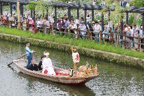 Bride on boat congratulated by onlookers in Itako, east of Tokyo