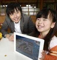 Girl shows picture drawn with Fukushima firm's app