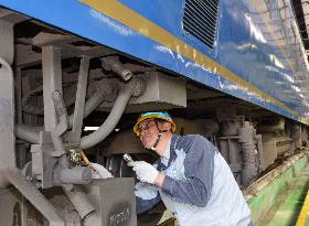 Veteran mechanic checks coach of luxury sleeper train