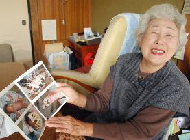 Woman shows photos of granddaughter found in quake debris in Japan