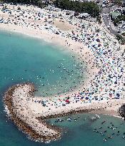 Crowded beach in sizzling Japan