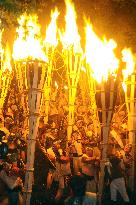 Young men march with huge torches at annual Kurama Fire Festival