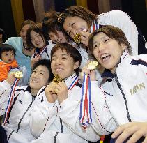 Japanese female wrestling medalists celebrate victories