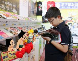 Visitor views "Astro Boy" comic at H.K. book fair