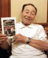 Hiroshima A-bomb survivor holds book on bomb's horrors