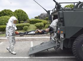 Japan army demonstrates transfer of person injured in volcanic eruption