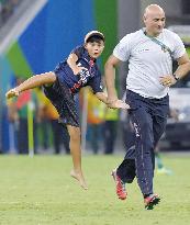 Olympics scenes: Child barges onto soccer pitch