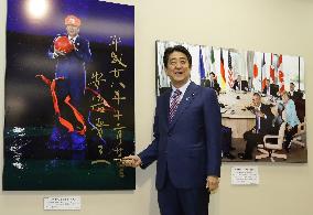 Abe visits news photo exhibit, sees photo of self as Super Mario