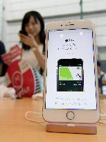 Apple's new iPhones go on sale in Japan