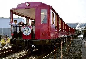 Steam locomotive train cars run with people aboard at Kyoto museum