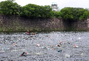 Triathletes swim in Osaka castle moat