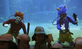 Goblin-mask divers delight kids at aquarium in western Japan