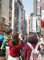 Tourist photographs Godzilla head in Tokyo's Kabukicho