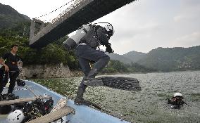 Searcher dives into dam lake to look for missing outside Tokyo