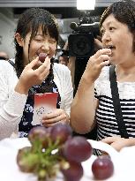 People queue for free tasting of extremely pricey grapes