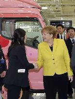 Merkel visits Daimler unit in Japan to see trucks for women