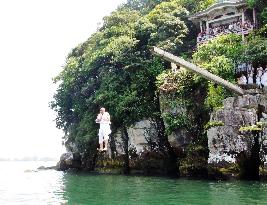Monks jump off beam at Lake Biwa in traditional ritual