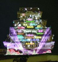 Words meaning "Thank you" projected on Himeji Castle