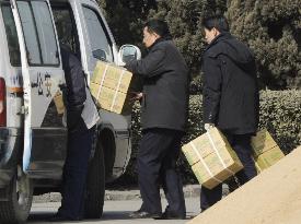 Packages possibly containing dumplings taken to police vehicle