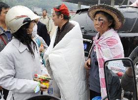 China earthquake -- wounded woman seeking refuge