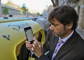 Barcelona city official checks dustbin via smartphone