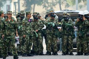 Armed police with gas masks ready to work at blast site