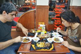Paraguayan couple tastes "wagyu" beef at Asuncion restaurant