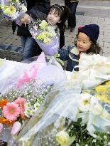Children lay flowers at scene of shooting rampage in Sasebo