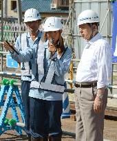 Transport minister Ota listens to female engineer