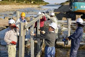 Fukushima fishermen repair trap for salmon fishing