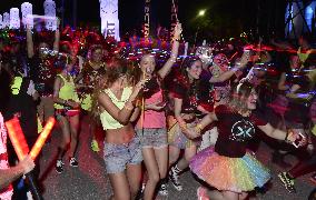 Participants run in glowing costumes