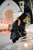 Visitor gazes at ice candles at Snow Crystal Museum in north Japan