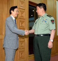 Japan PM's top national security aide meets China's defense minister