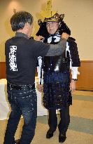 'Cool Japan' strategy minister tries on paper-made armor