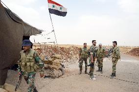 Soldiers guard checkpoint in southern Syria