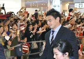 Japan rugby team returns home