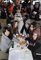 Young women drink beer at wining/dining event in western Japan