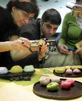 Romans busy taking photos of Japan sweets